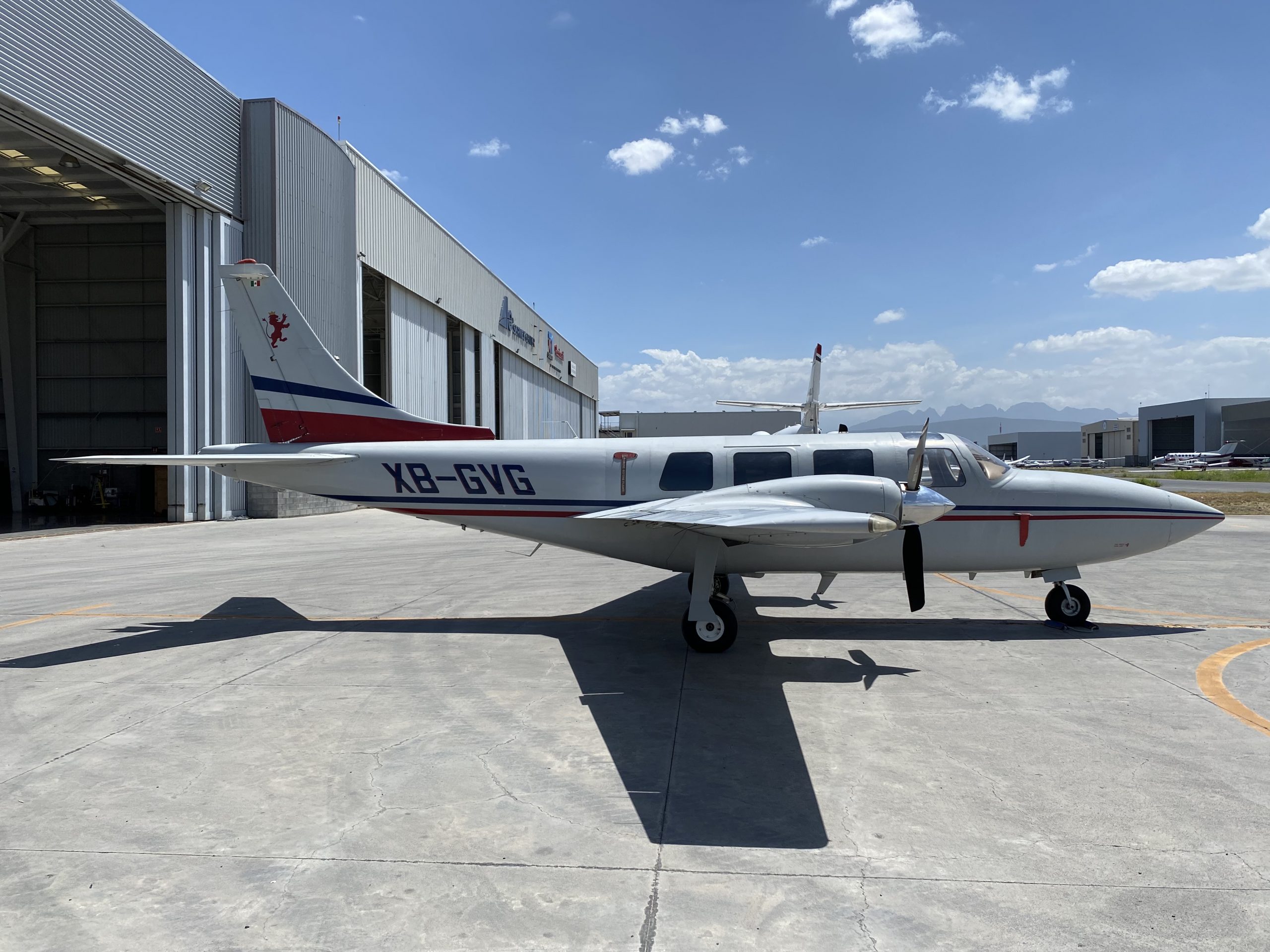 Side view of the XB-GVG aircraft with a white and red paint scheme parked on the tarmac.